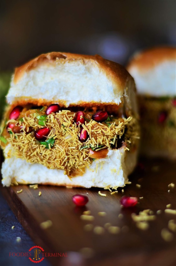 Dabeli, Kutch dabeli or double roti is a popular snack food originating in the Kutchof Gujarat. Dabeli literally means "pressed" in Gujarati.It is made with mixing boiled potatoes with a special masala and served with chutney, pomegranate and roasted peanuts.